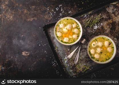 Fresh meat soup in bowl on dark background, top view