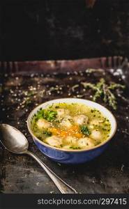 fresh meatball soup in bowl on dark background, dark background