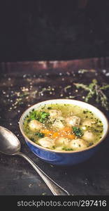 fresh meatball soup in bowl on dark background, dark background