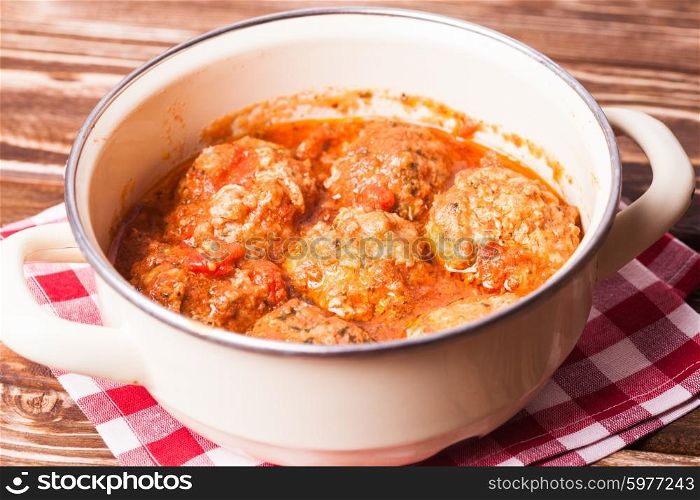 Fresh meatballs under tomato sauce close up. Meatballs with tomato sauce