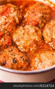 Fresh meatballs under tomato sauce close up. Meatballs with tomato sauce