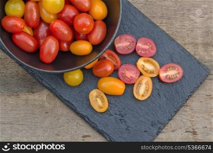 Fresh Meli Melo Heirloom tomatoes in rustic setting