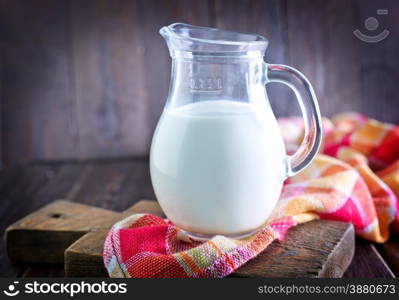 fresh milk in jug and on a table