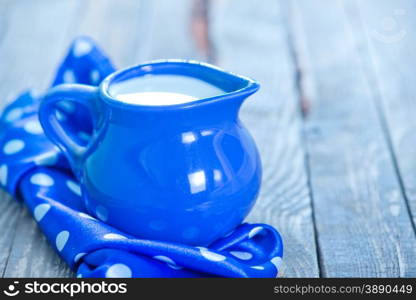 fresh milk in jug and on a table