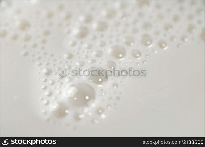 Fresh milk with air bubbles. Macro background. High quality photo. Fresh milk with air bubbles.