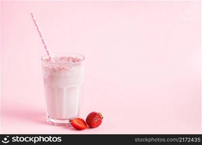 Fresh milkshake with strawberries on a pink background. Summer detox drink. Place for text.. Fresh milkshake with strawberries on pink background. Summer detox drink. Place for text.