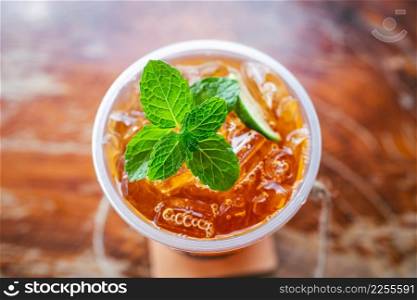 fresh mint on ice in glass with slice lime