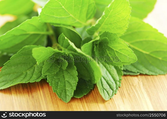 Fresh mint sprigs on wooden cutting board