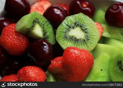 Fresh mixed fruit salad in green and red