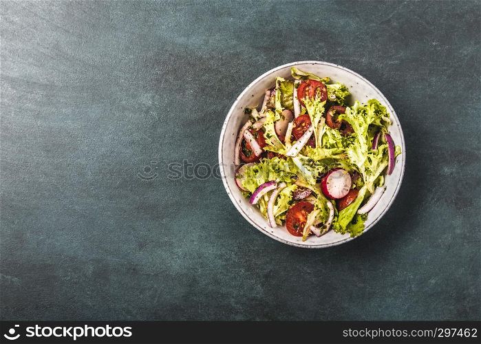 Fresh mixed salad with tomatoes, top view