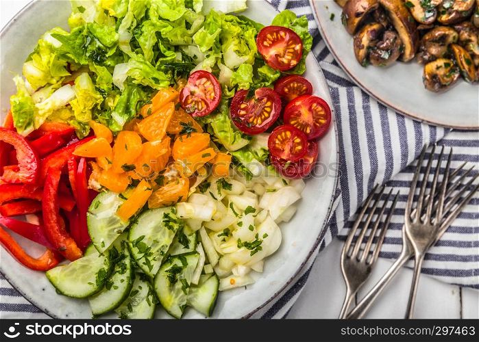 Fresh mixed salat with herbs and mushrooms, top view,