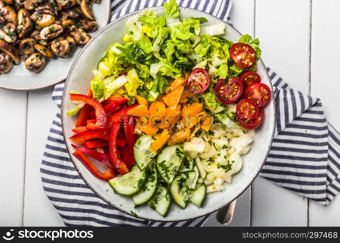 Fresh mixed salat with herbs and mushrooms, top view,