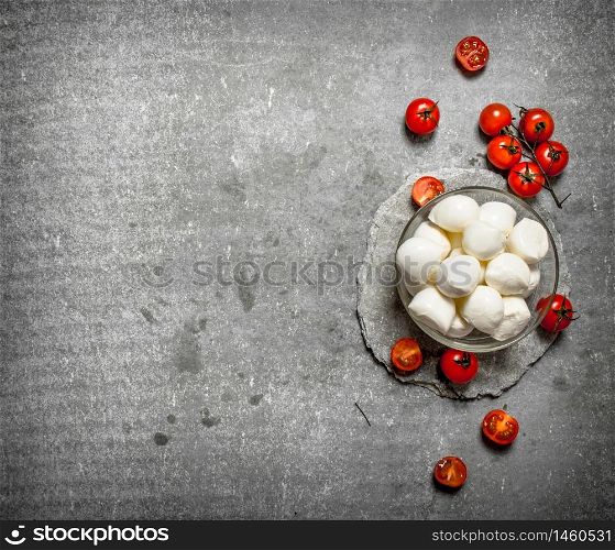 Fresh mozzarella with tomatoes. On the stone table.. Fresh mozzarella with tomatoes.