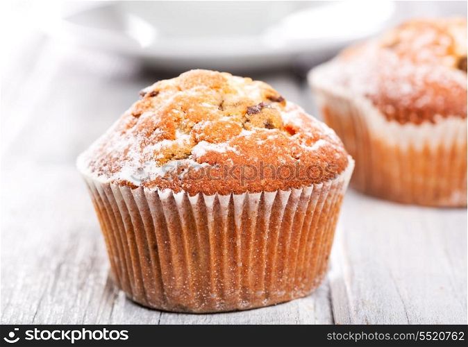 fresh muffins on wooden table