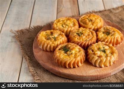 Fresh muffins with vegetables and cheese on a wooden board. Delicious homemade cakes for healthy diet. Recipe for autumn seasonal dish.. Fresh muffins with vegetables and cheese on wooden board. Delicious homemade cakes for healthy diet. Recipe for autumn seasonal dish.