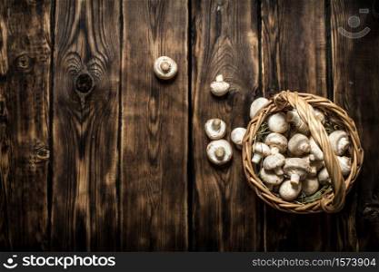 Fresh mushrooms in basket. On a wooden background.. Fresh mushrooms in basket. On wooden background.