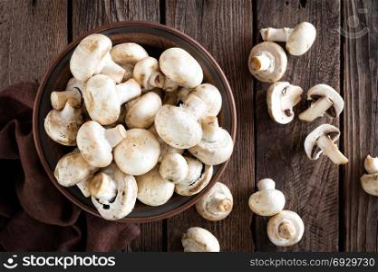 Fresh mushrooms on wooden table, top view