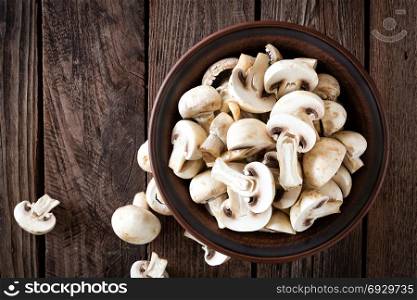 Fresh mushrooms on wooden table, top view