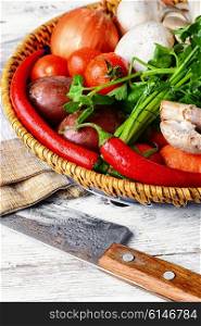 Fresh mushrooms,tomatoes,peppers and onions on a light wooden background