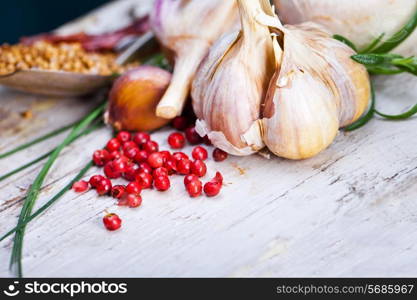 Fresh mushrooms with spices and herbs on old wooden board.