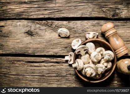 Fresh mushrooms with spices. On wooden background.. Fresh mushrooms with spices.