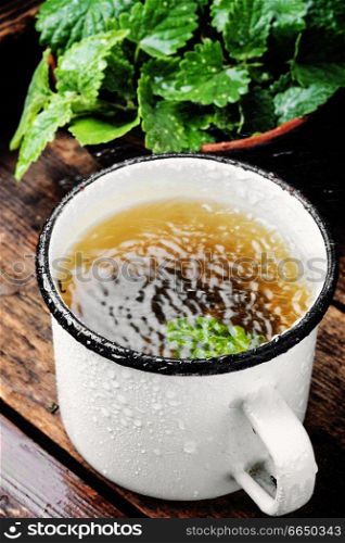 Fresh natural green melissa herbal tea in cup.Healthy beverage. Cup of melissa tea