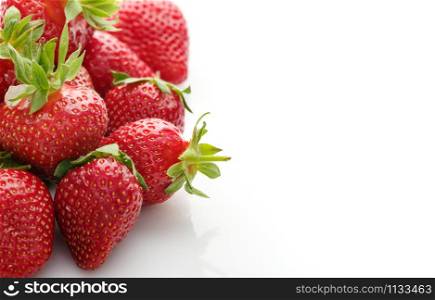 Fresh natural strawberries on white background with place for text. Copyspace.
