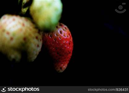 Fresh of strawberry with closeup on black background.
