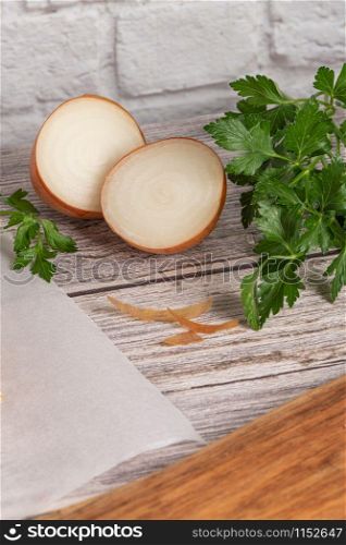 Fresh onions and parsley on rustic wooden background. Onions background. Ripe onions.
