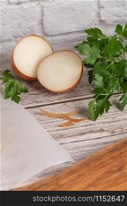 Fresh onions and parsley on rustic wooden background. Onions background. Ripe onions.