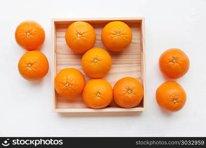 Fresh orange citrus fruit in wooden box.. Fresh orange citrus fruit in wooden box isolated on white background. Top view