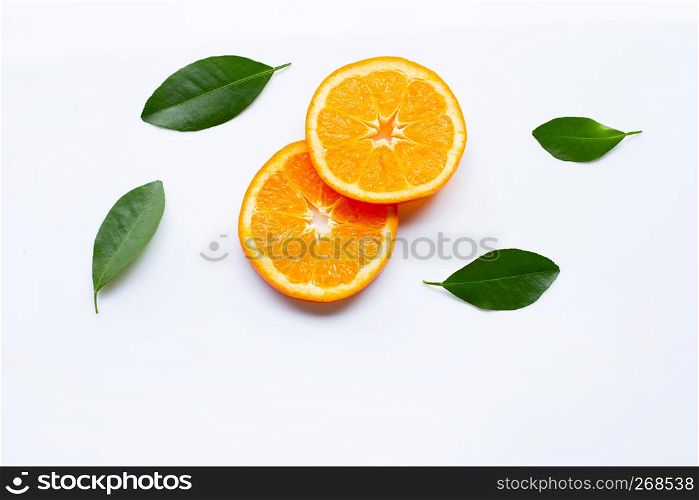 Fresh orange citrus fruit slices with leaves on white background. Top view