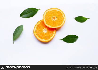 Fresh orange citrus fruit slices with leaves on white background. Top view