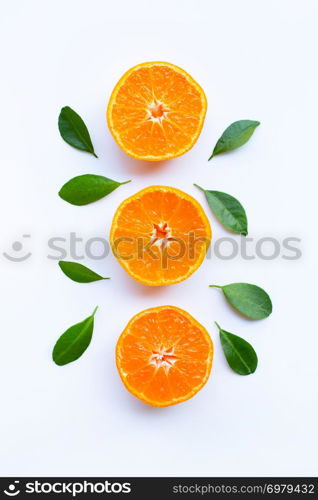 Fresh orange citrus fruit with green leaves on white background.