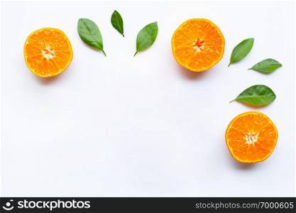 Fresh orange citrus fruit with green leaves on white background. Copy space