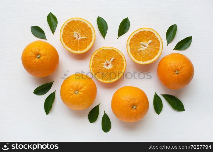 Fresh orange citrus fruit with leaves isolated on white background. Top view