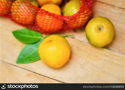 Fresh orange fruit on wooden background / harvest orange and orange leaf healthy fruits concept