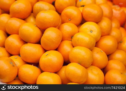 fresh orange fruits are sold in the market.