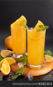 Fresh orange juice in glass with mint, fresh fruits. selective focus.