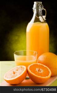 fresh orange juice inside a glass on wooden table