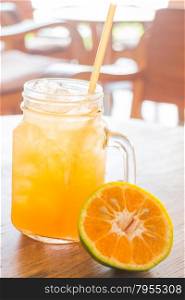 Fresh orange juice serving on wooden table, stock photo