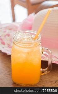 Fresh orange juice serving on wooden table, stock photo