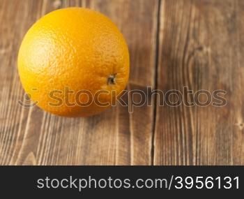 fresh orange lying on the board. orange lies on the old board
