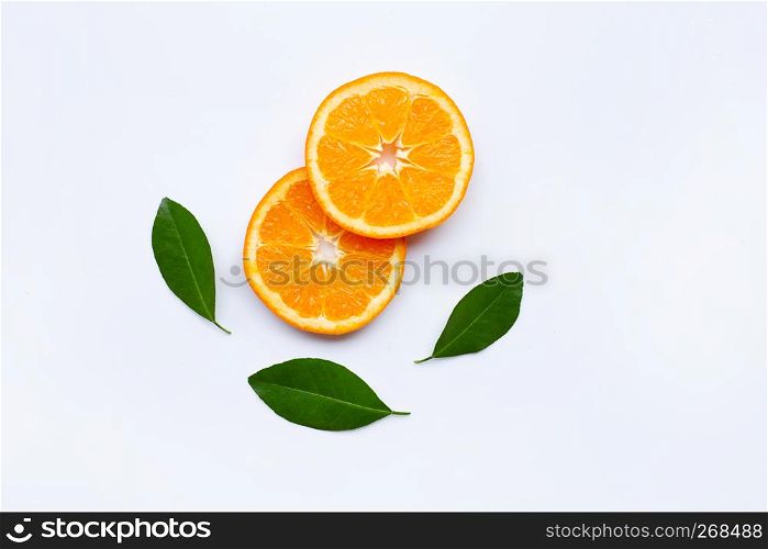 Fresh orange slices, citrus fruits with leaves on white background. Top view