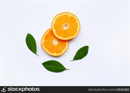 Fresh orange slices, citrus fruits with leaves on white background. Top view