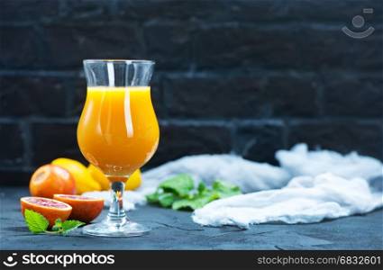 fresh oranges and juice in glass on a table