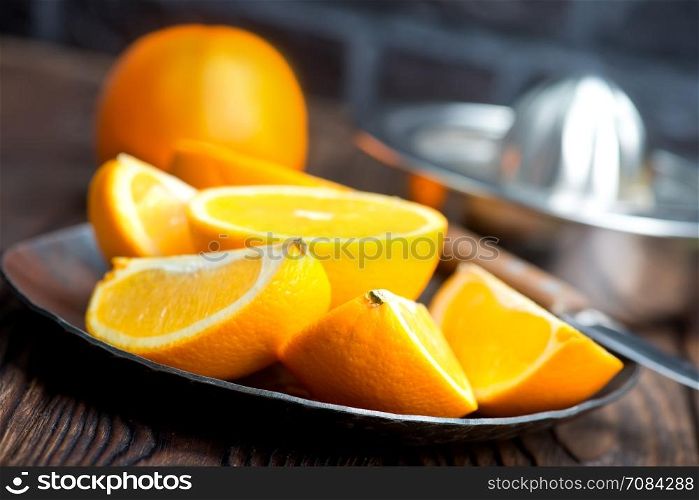 fresh oranges on the wooden board and on a table