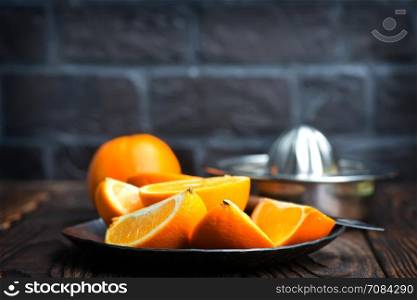 fresh oranges on the wooden board and on a table