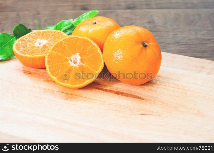 Fresh oranges on wooden table in kitchen