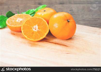 Fresh oranges on wooden table in kitchen